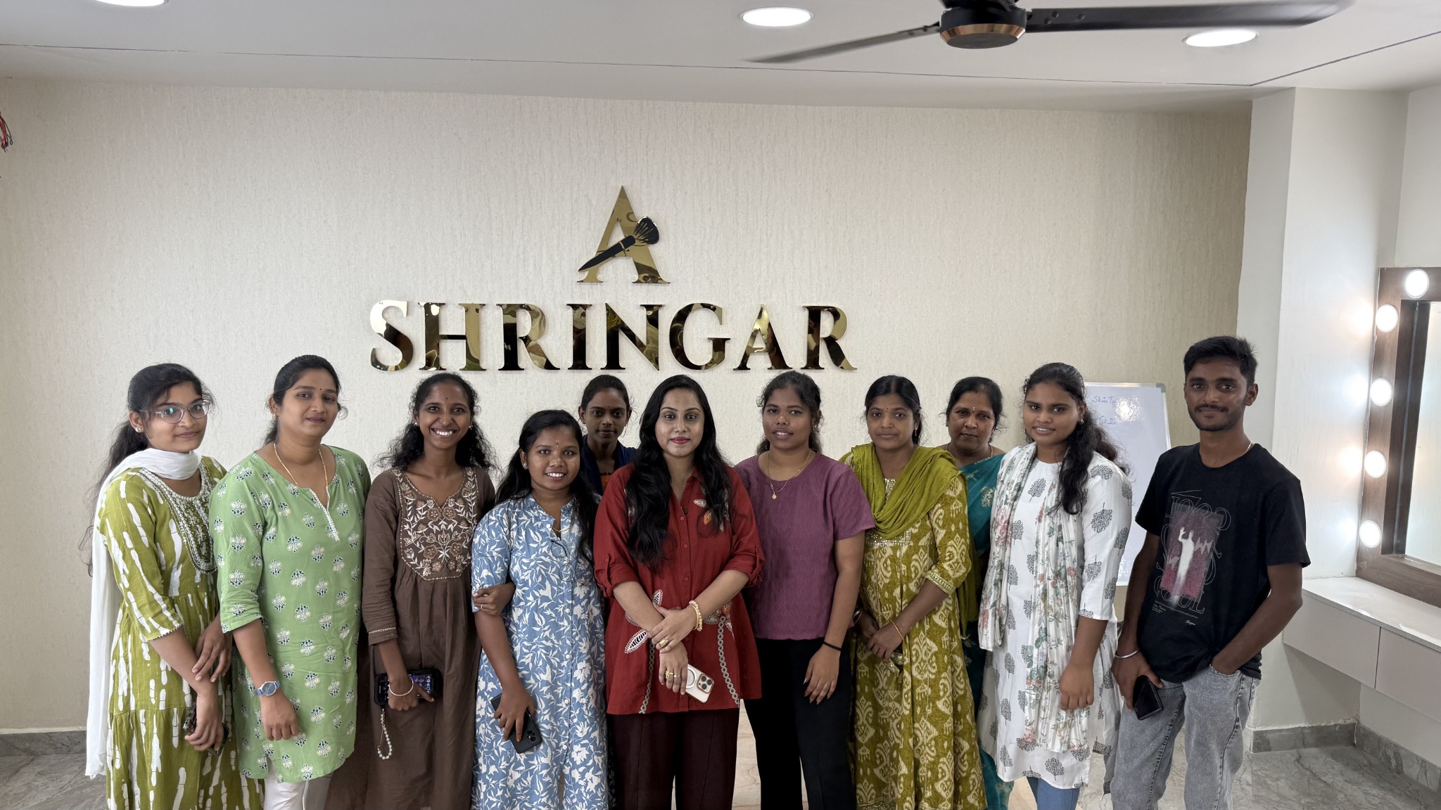 Shringar Makeup Academy students standing together beneath the Shringar academy logo